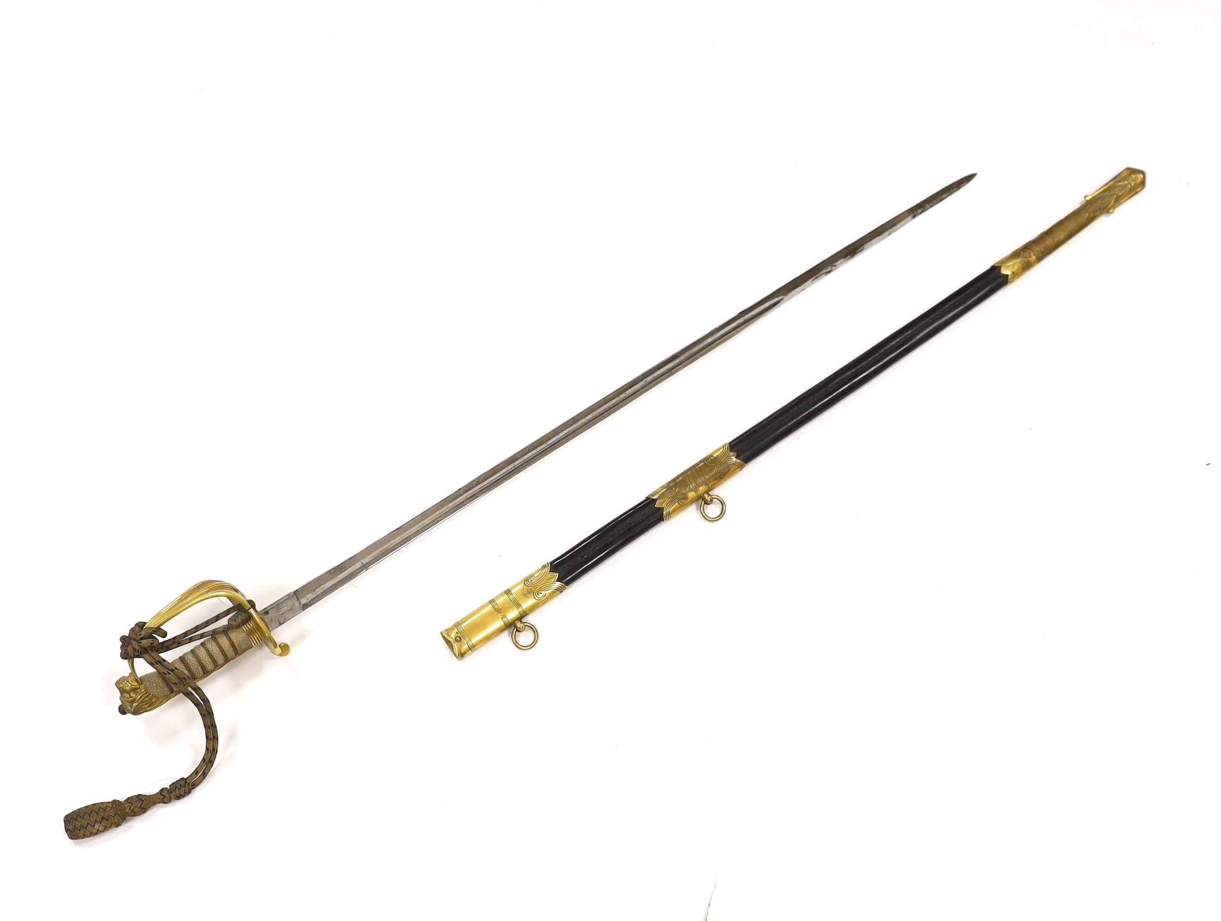 A World War I naval sword with folding guard engraved J.W. Collett R.N., regulation gilt hilt and scabbard mounts, the blade has been refinished and furniture regilded, with bullion dress knot, blade 78.5cm